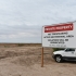 A sign reading "Private Property - No Trespassing - Active Geothermal Area - Violaters will be prosecuted."